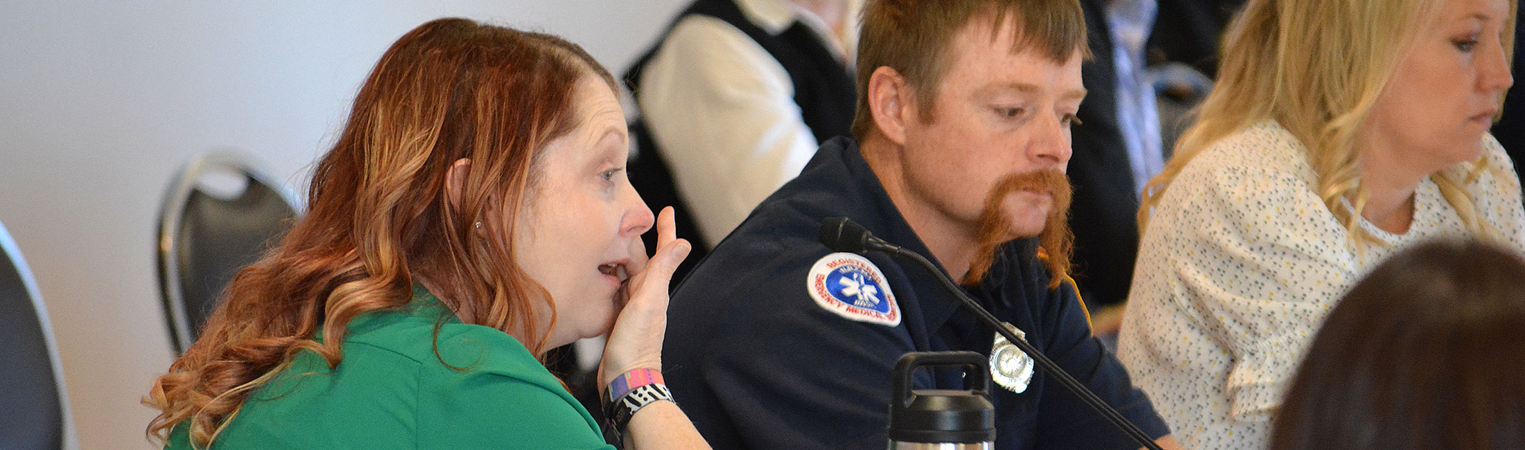 Women at a meeting crying.