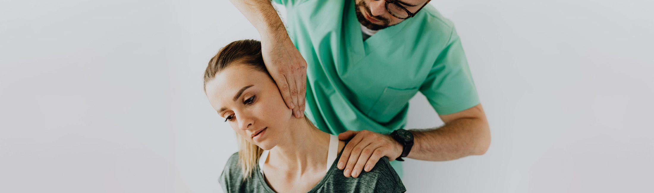 doctor examining woman's neck