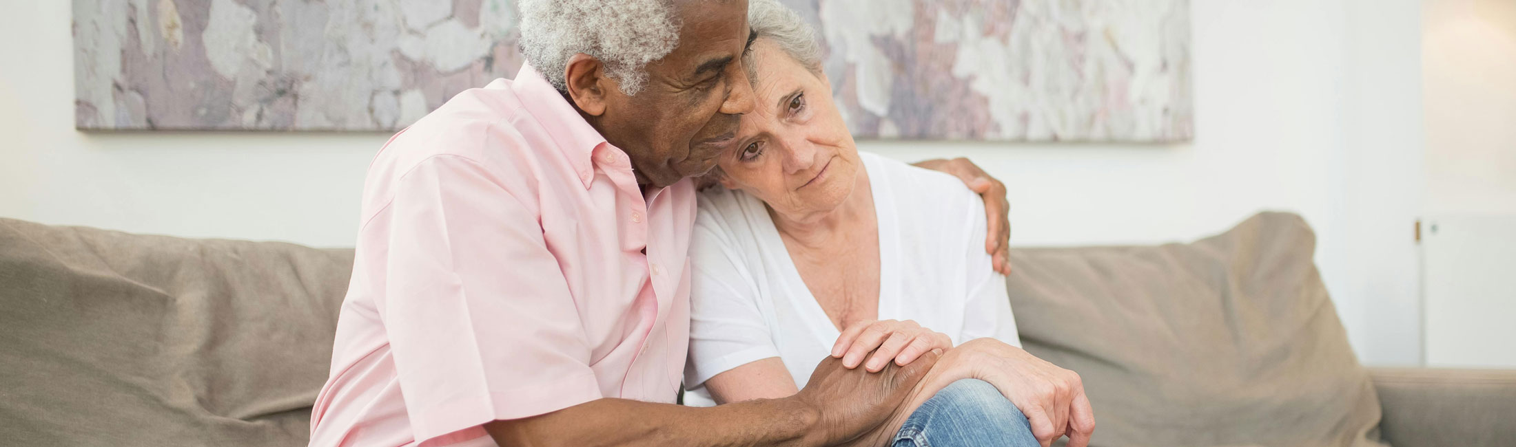 man and woman sitting on couch