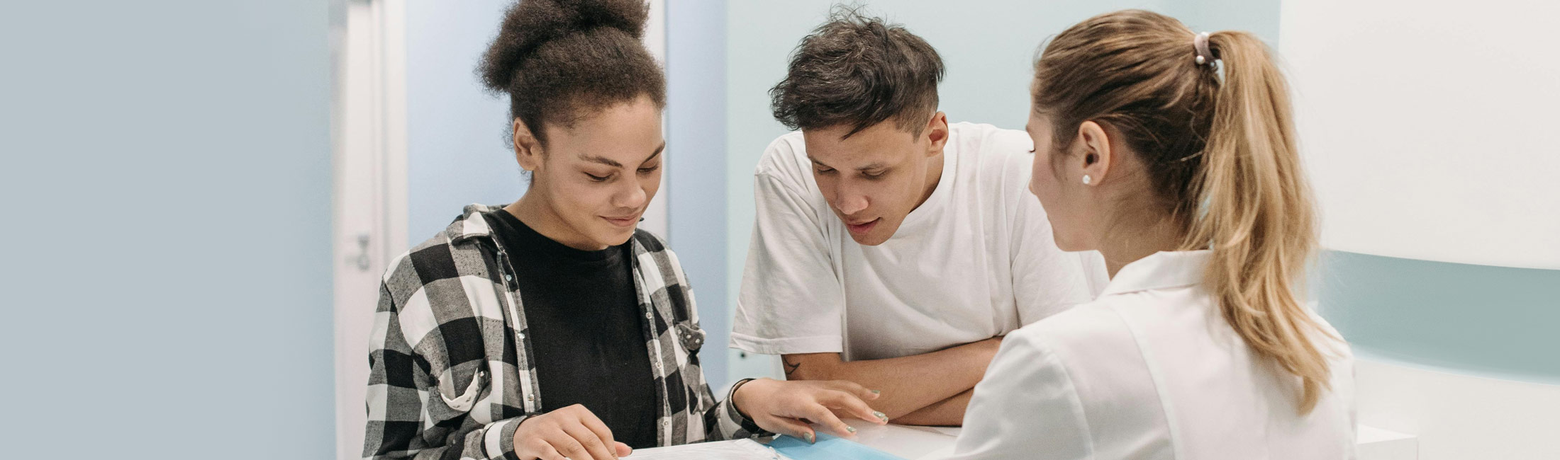 man and woman at hospital front desk