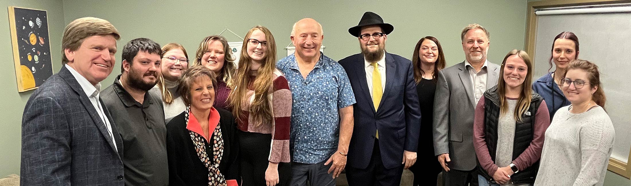 Department of Public Health and Human Services staff with Chabad Lubavitch of Montana and various community partners standing in room