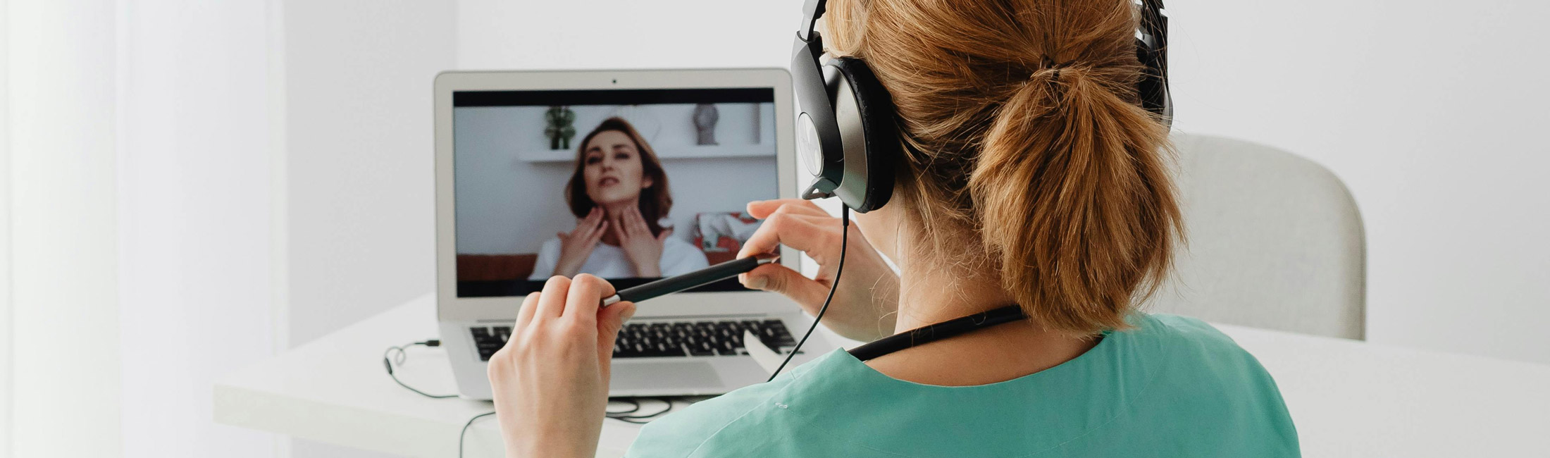 Woman having a telehealth doctors visit on laptop