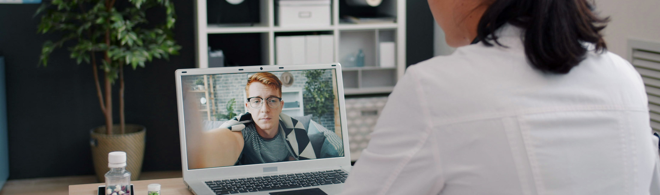 medical professional woman meeting with telehealth patient on laptop