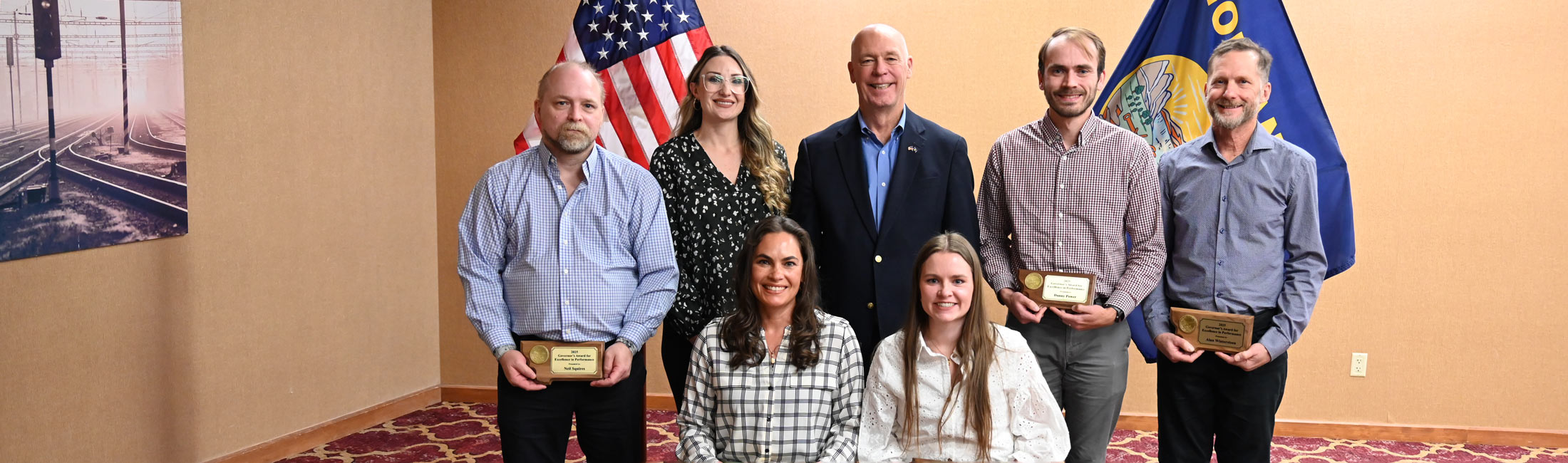 Governor Greg Gianforte and DPHHS staff members holding awards
