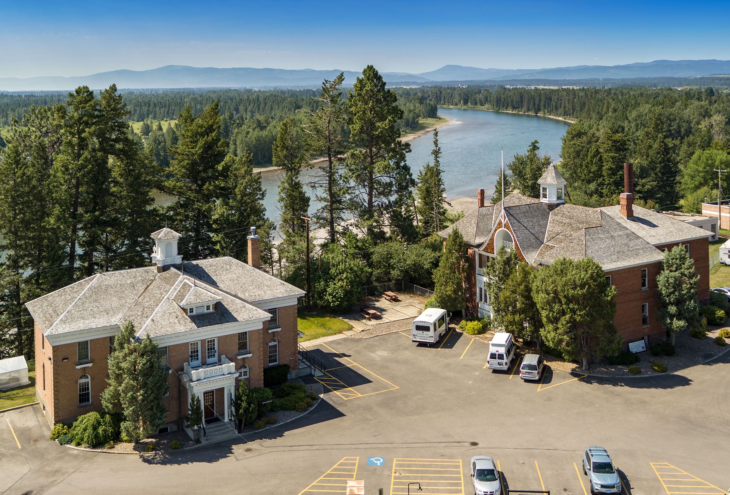An aerial view of two main buildings on the Veterans home campus. The flathead river is in the background.