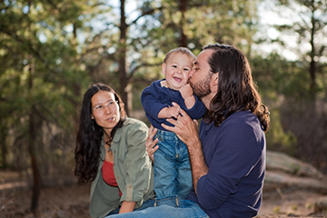 Mother, father, child in the woods