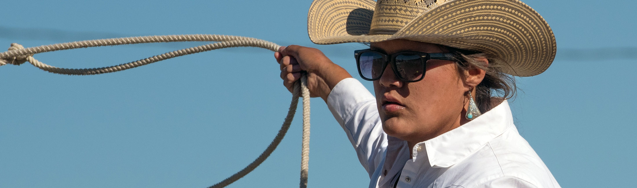 Woman in cowboy hat with lasso