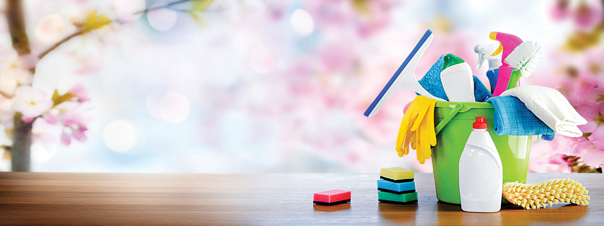 Spring cleaning suppliies with a blossoming cherry tree in the background